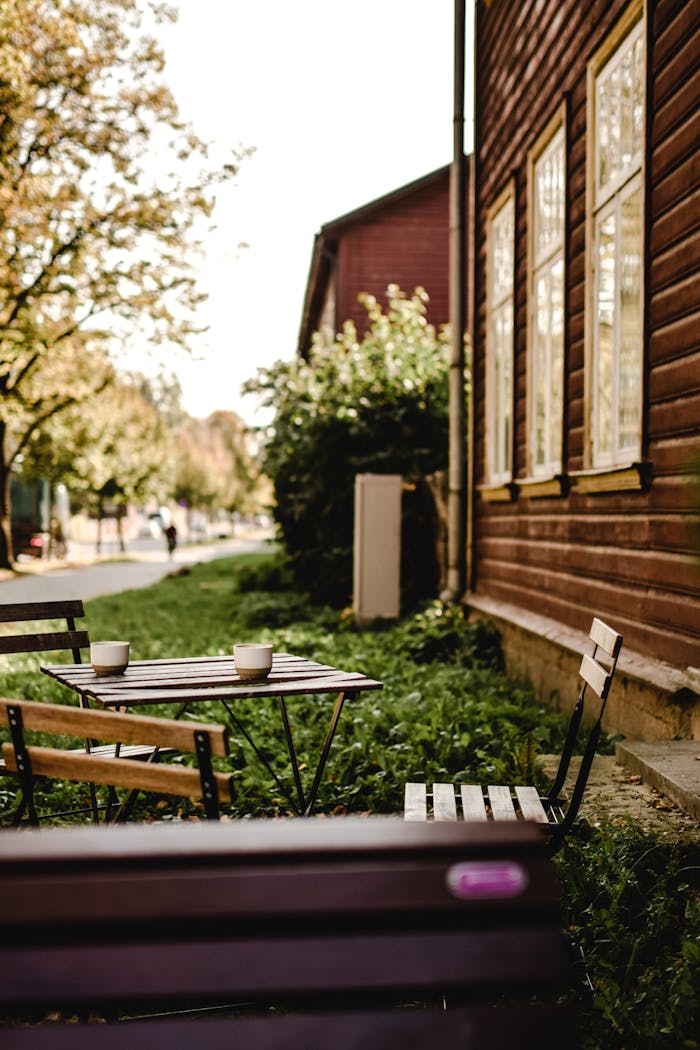 services-03 Charming wooden chairs and table outside a cafe in Tartu, Estonia, in autumn.